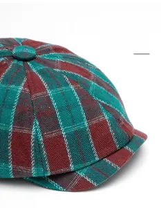Close-up of classic red and green plaid pattern on the foldable brim of the newsboy cap