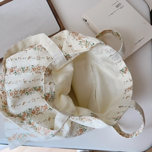 Detailed interior of floral cotton tote bag showing inner pocket and pattern