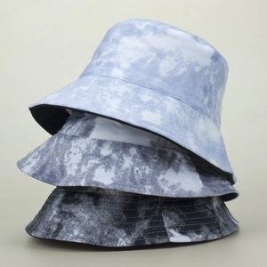 Detail showing high-quality stitching and artisanal tie-dye patterns on canvas bucket hats