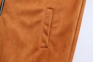 Macro detail of camel faux suede fabric texture and silver metal zipper on men's jacket