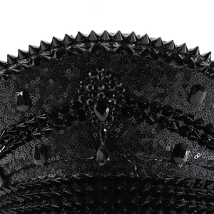 Detail of black sequined captain hat with gothic studs and rhinestone embellishments