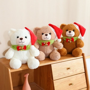 Three plush Christmas teddy bears in brown and white with festive hats and scarves