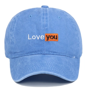 Detailed view of Love you embroidery on washed blue cotton vintage baseball cap