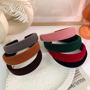 Close-up of elegant velvet padded sponge headbands in multiple retro colors for women