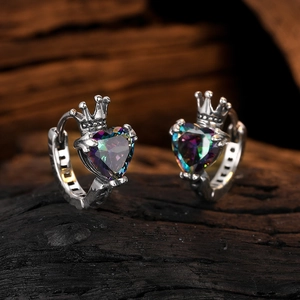 Retro silver crown hoop earrings with heart-shaped rainbow zircon on wood background