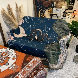 Bohemian dark blue woven camping blanket with moon and snake patterns and fringed edges