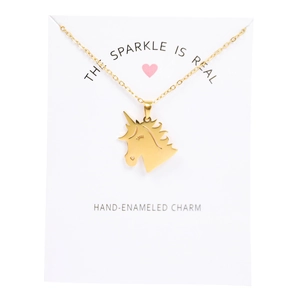 Detail of hand-enameled golden unicorn charm necklace with heart on display card
