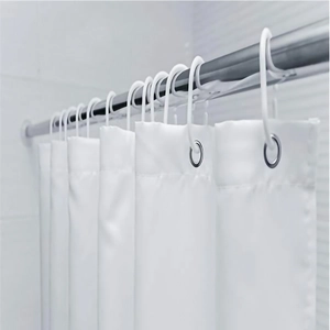 Close-up of rust-proof metal eyelets and C-type plastic hooks on a white shower curtain
