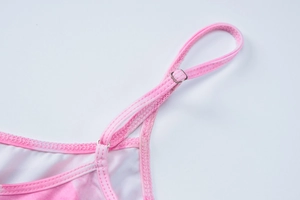 Close-up of adjustable metal buckle and pink thin shoulder strap on floral summer top