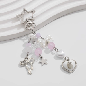 Star-shaped keychain with cat heart pendant and pink bow on white plaster stone