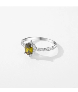 Macro view of vintage s925 silver ring with oval olive green gemstone and intricate details