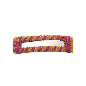 Detail of purple and ginger yellow knitted yarn hair clip with handmade woven texture