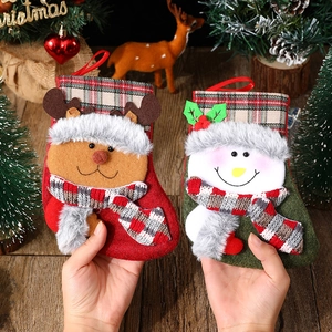 Christmas stocking gift bags featuring reindeer and snowman with plaid cuffs and hanging loops