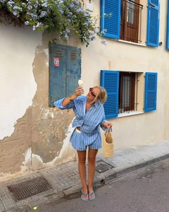 Close-up of blue and white striped long-sleeve shirt and shorts set for casual vacation