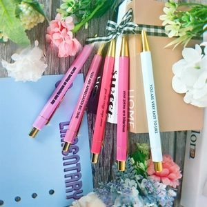 Close-up of a 5-piece nurse motivational ballpoint pen set with gold clips and gift box