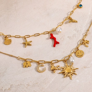 Golden stainless steel chain with assorted ocean and star charms like shells and starfish
