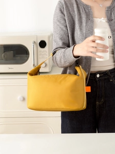 Detail of a bright yellow insulated lunch bag made from durable tear-resistant nylon fabric