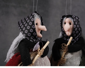 Detailed view of handmade fabric witch dolls with brooms for Halloween decoration