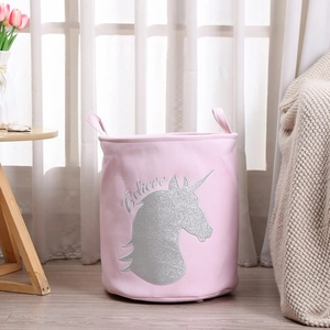 Detail of pink unicorn laundry basket with silver glitter prints and soft fabric texture