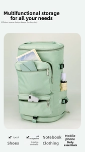 Detailed interior storage layout of the green waterproof travel duffel with dry-wet pockets