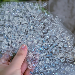 Holographic heart and letter nail stickers set showing reflective finish in hand