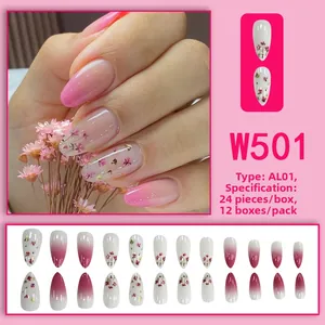 Macro detail of gradient blush press-on nails with dried flowers and gold foil accents