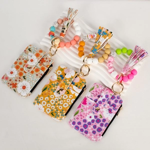 Detail of floral zipper wallet with beaded wristlet, silicone beads and tassel detail