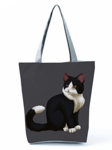 Detailed close-up of dark grey canvas tote bag featuring a cute black and white cat print