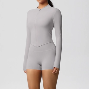 Detail of grey yoga set featuring a half-zip long sleeve top and athletic shorts
