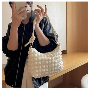 Chic bubble texture shoulder bag in off-white featuring a stylish knotted strap detail