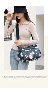 Detail of floral printed crossbody bag with multi-layer metal zippers and wide strap