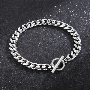 Minimalist silver Cuban chain bracelet with OT toggle clasp on textured gray background