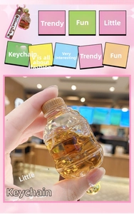 Detail of creative soda bottle keychain with leather strap and golden ring hook