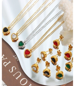 Close-up of heart-shaped jewelry set with multi-color zircon stones in gold and silver plating