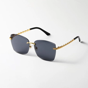 Detail of vintage rectangular sunglasses with gold chain temples and CD logo accent