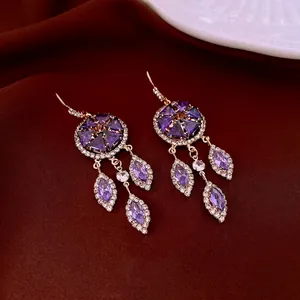 French palace style gold tassel earrings with purple crystals and sparkling zircons