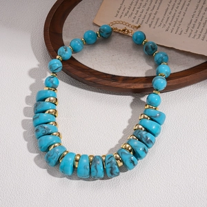 Detailed shot of bohemian acrylic marble beads and gold spacers on a vintage tray