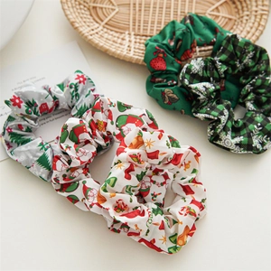 Detail of Christmas scrunchies featuring Santa Claus, tree, and green plaid patterns