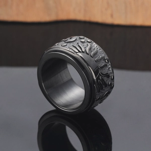 Detail view of black stainless steel spinning ring with embossed solar moon patterns