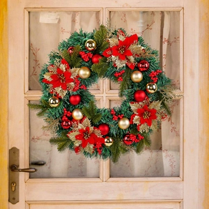 Classic Christmas wreath with red flowers and gold ornaments on a beige wooden door