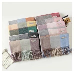 Close-up of soft plaid scarves featuring colorful knit texture and fringe tassels detail