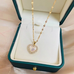 Elegant gold titanium heart necklace with iridescent pearl and sparkling zircon stones