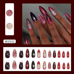 24pcs deep red stiletto press-on nails with wavy star patterns and gold accents