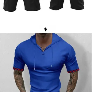 Detail of blue waffle knit hoodie with drawstring V-neck and plaid trim on sleeves