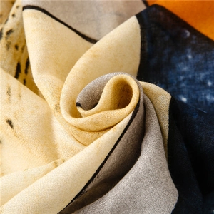 Macro detail of breathable cotton-linen scarf showing soft texture and ink-wash pattern