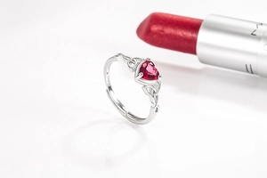 Close-up of S925 sterling silver ring with heart-shaped red zircon and Celtic knot detail