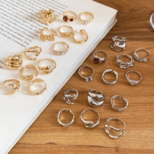 Detailed view of layered ring set featuring lava texture and ruby-like stone accents