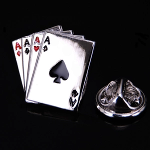 Detailed view of silver poker Ace brooch set with red and black enamel on black background