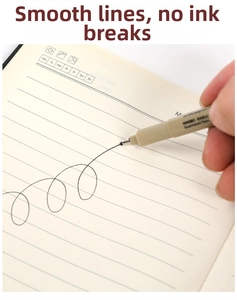 Close-up of waterproof fineliner pen drawing smooth black ink lines on a paper notebook