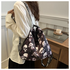Detail of nylon crossbody bag featuring skull floral print and LOVE letter strap